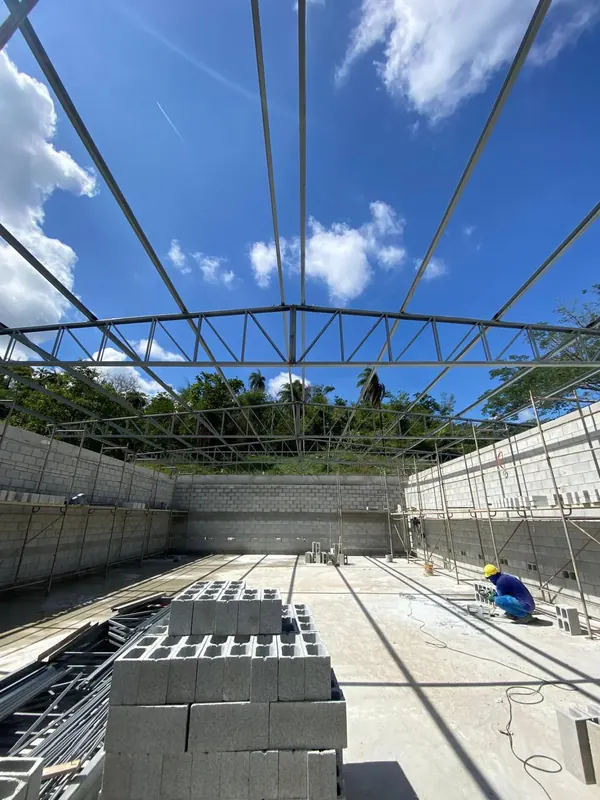 Treliças e terças da cobertura montadas, vistas de baixo contra o céu