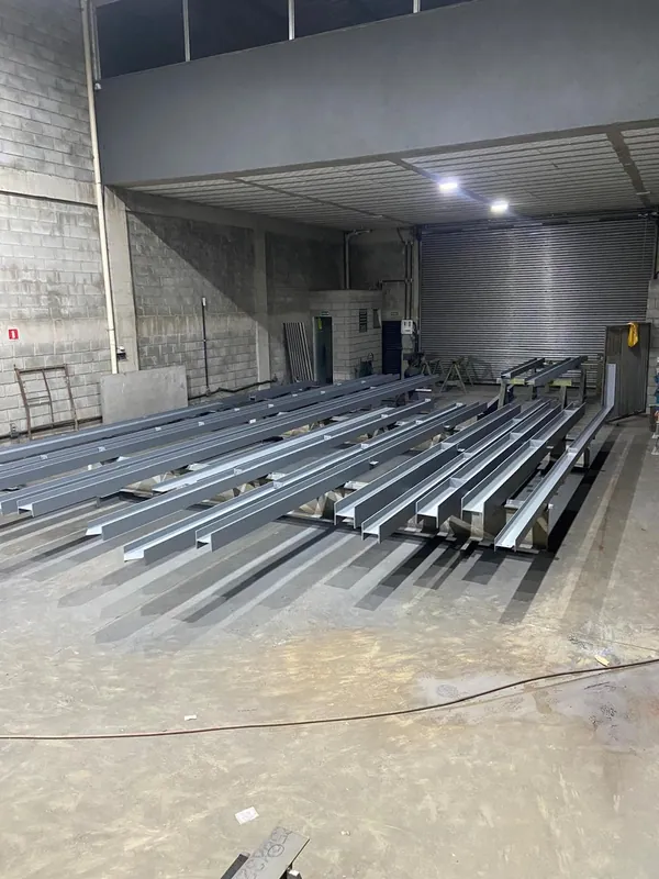 Vigas e pilares pintados no piso da fábrica, prontos para a coleta