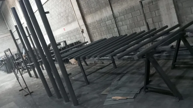 Tubos com pintura anticorrosiva sobre cavaletes, na fábrica